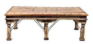 An Indian Carved Wood Low Table Height 24 1/2 x width 72 x depth 40 1/2 inches.