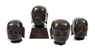 Four Stone Heads of Buddha Height of tallest 13 1/2 inches.