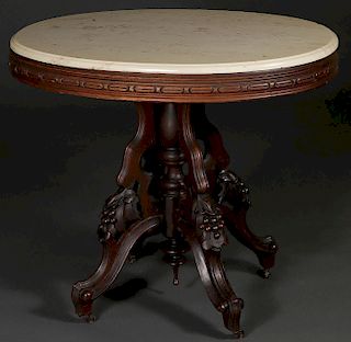 A CARVED VICTORIAN WALNUT LAMP TABLE