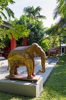 A Pair of Indian Teak Models of Elephants Width 52 inches.