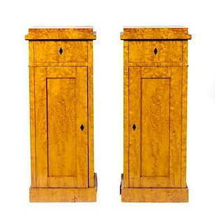A Pair of Biedermeier Burlwood Veneered Pedestal Cabinets Height 48 x width 19 x depth 17 inches.