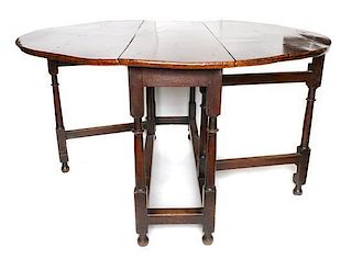 A George II Oak Gate-Leg Table, Height 27 3/4 x width 45 x depth 15 inches (closed).