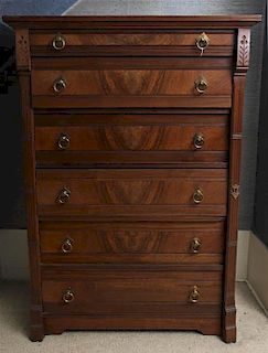 An Eastlake Walnut Wellington Chest of Drawers, Height 53 1/2 x width 37 3/4 x depth 20 3/4 inches.