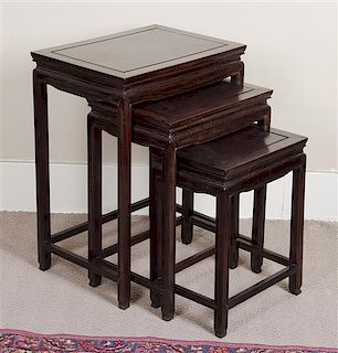 A Set of Chinese Teak Nesting Tables, Height 25 1/2 x width 19 1/2 x depth 14 inches.