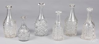 Six colorless glass decanters