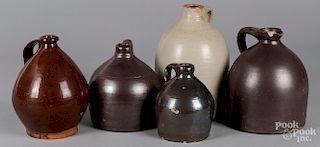 Five redware and stoneware jugs