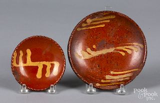 Two small slip decorated redware plates