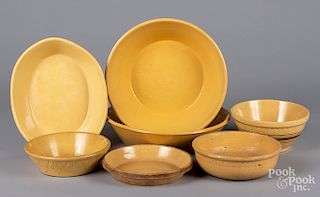 Seven yelloware bowls and serving dishes.
