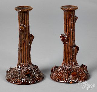 Pair of redware tree trunk candlesticks
