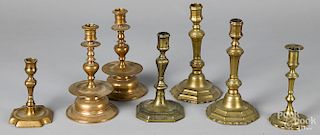 Seven brass and bell metal candlesticks