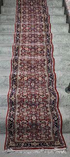 An Indo-Persian Wool and Cotton Runner. 17 feet 6 inches x 2 feet 4 inches.