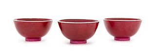 * Three Chinese Sang-de-Boeuf Porcelain Tea Bowls Diameter of each 2 3/4 inches.