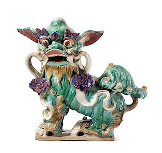 * A Chinese Green, Aubergine and Yellow Glazed Pottery Fu Lion-Form Roof Tile Height 17 inches.