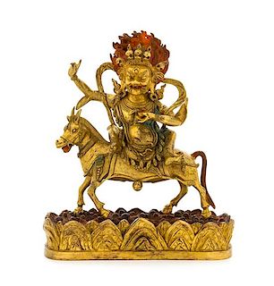 A Sino-Tibetan Gilt Bronze Figure of Magzor Gyalmo Total height 11 1/4 inches.