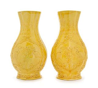 A Pair of Carved Yellow Glazed Porcelain Vases Height 11 1/2 inches.