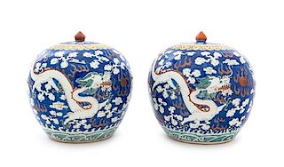 A Pair of Blue Ground Iron Red and Green Decorated Porcelain Ginger Jars and Covers Height of each 9 3/8 inches.