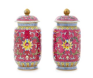 * A Pair of Ruby Pink Ground Famille Rose Porcelain Covered Jars Height of each 6 1/4 inches.
