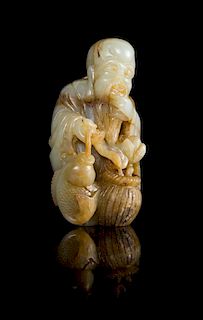A Celadon and Brown Jade Figure of the Immortal of Longevity, Shoulao Height 5 1/8 inches.