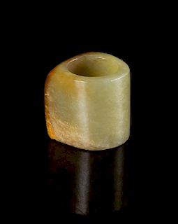 A Celadon and Russet Jade Archer's Ring Length 1 1/8 inches.
