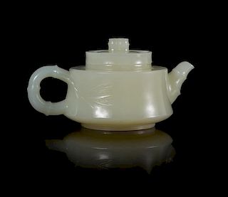 A Carved White Jade Teapot Width 3 7/8 inches.