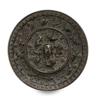 A Bronze 'Beast and Grapevine' Mirror Diameter 5 1/2 inches.