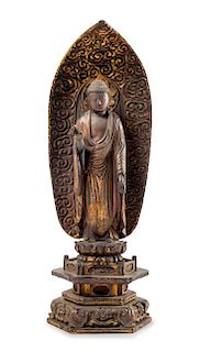 * A Japanese Gilt Lacquered Wood Figure of Buddha Height 14 1/8 inches.