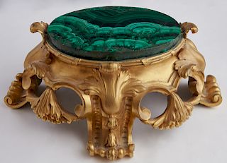 Malachite and Gilt Bronze Plateau, 19th c., and later, with a thick oval malachite plate on a pierced relief decorated bronze stand on four splayed sc