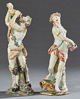Two Polychromed Porcelain Figures, late 19th c., of Pan with a wine skin, on an integral base with a tree trunk and a basket of grapes; and a nude wom