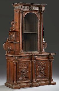 French Henri II Style Carved Oak Buffet a Deux Corps, c. 1880, the stepped breakfront crown over a central arched glazed door, flanked by tapered reed