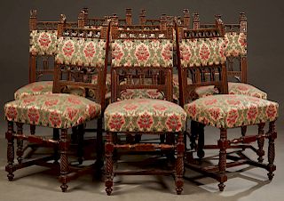 Set of Eight French Henri II Style Carved Walnut Dining Chairs, c. 1880, the pierced crests above upholstered splats and spindled arches above an upho
