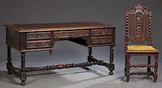 French Henri II Style Carved Oak Desk, late 19th c., the medallion carved edge top with an inset gilt tooled leather over a center drawer, flanked by 