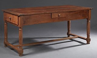 French Provincial Carved Cherry Farmhouse Table, 19th c., the plank top over a wide skirt with two end drawers and one side drawer, on turned trestle 