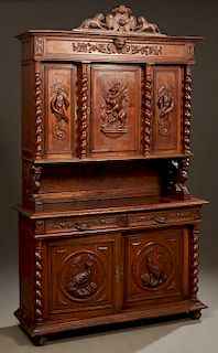 French Henri II Style Carved Oak Buffet a Deux Corps, c. 1880, the pierced lion and shield crest over a stepped crown above triple setback cupboard do