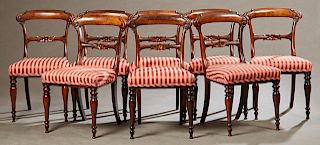 Set of Eight English Victorian Carved Rosewood Dining Chairs, 19th c., the arched curved crest rail over a floral carved horizontal splat, to an uphol