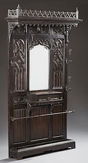 French Gothic Style Carved Oak Hall Stand, late 19th c., the pierced trefoil crest over a stepped crown with an arched skirt, above a Gothic arch fram