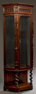 French Gothic Style Carved Oak Vitrine, late 19th c., with a pierced quatrefoil and shield crest over a stepped pentagonal crown with pierced quatrefo