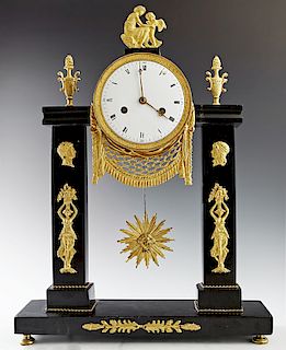 French Empire Gilt Bronze and Marble Portico Clock, circa 1820, with a surmount of a woman and a cherub over an enamel face drum clock, time and strik
