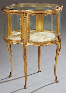French Style Giltwood Ormolu Mounted Curved Glass Table Vitrine, 20th c., of quatrefoil form, the beveled glass top over curved glass sides, on slende
