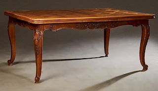 French Louis XV Style Carved Walnut Drawleaf Dining Table, 20th c., the parquetry inlaid top over a serpentine skirt, on cabriole legs with scrolled t