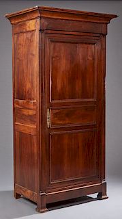 French Louis Philippe Carved Walnut Bonnetiere, c. 1860, the stepped cavetto crown above a setback three paneled door enclosing a shelved interior, fl