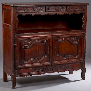 French Louis XV Style Carved Oak Server, 20th c., the stepped edge rounded corner top over three frieze drawers above an open shelf and two arched fie
