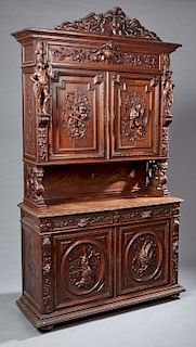 French Henri II Style Carved Oak Buffet a Deux Corps, c. 1881, the carved deer and gryphon crest over a stepped crown above setback double cupboard do
