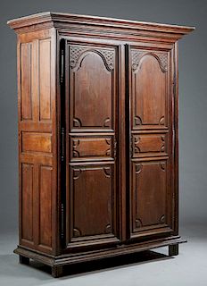 French Louis XVI Style Carved Oak Armoire, early 19th c., the stepped ogee crown over two triple paneled doors with applied carving and three steel fi