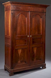 French Provincial Louis Philippe Style Carved Walnut Armoire, 19th c., the stepped ogee crown over two triple paneled doors, flanked by fluted pilaste