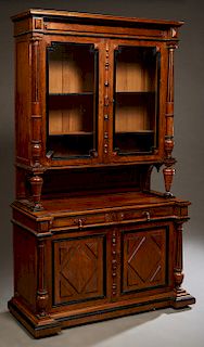 French Carved Walnut Buffet a Deux Corps, c. 1870, the stepped crown over setback double glazed doors, flanked by turned tapered fluted columns on tap