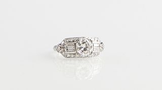 Lady's Platinum Engagement Ring, 20th c., with a round one carat diamond, flanked by baguette diamonds, within a border of three point diamonds, diamo