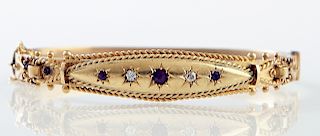 English 15K Yellow Gold Hinged Bangle Bracelet, Birmingham, c. 1900,, the tapered top with three rubies, separated by two 5 point round diamonds, all 