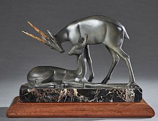 French School, "Pronghorn Antelope and its Mate," 20th c., patinated spelter figural group, on a highly figured black marble base now with a mahogany 
