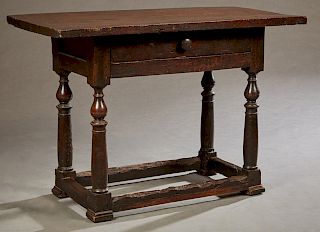 French Provincial Carved Oak Writing Table, 19th c., the rectangular top over a wide skirt with a frieze drawer, on turned tapered trestle supports jo