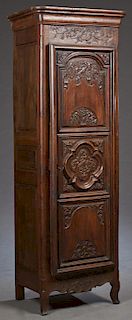 French Renaissance Style Carved Oak Bonnetiere, c. 1850, the stepped rounded corner crown, over a triple panel door with relief floral and bird carvin